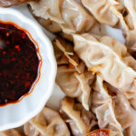 Chinese pork dumplings with spicy dipping sauce.