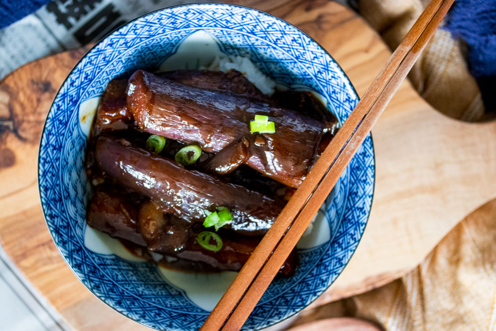 Braised Chinese eggplants in a bowl.