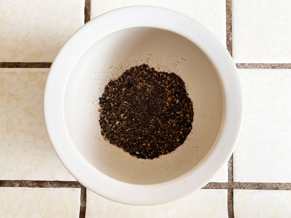 overhead shot of grinded whole peppercorn and salt