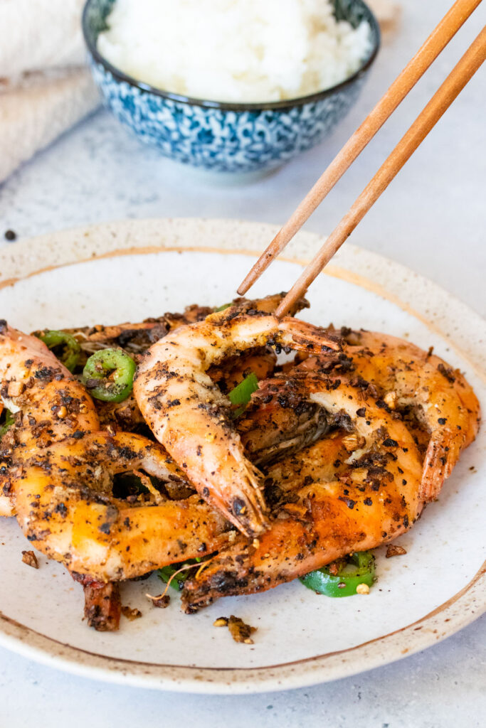 chopsticks picking up salt and pepper shrimp