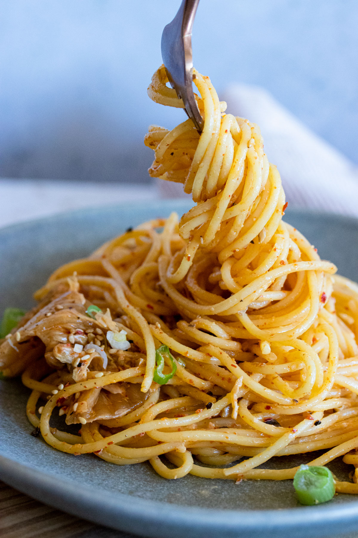 Creamy kimchi pasta twirled on a fork. 