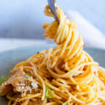 Creamy kimchi pasta twirled on a fork.