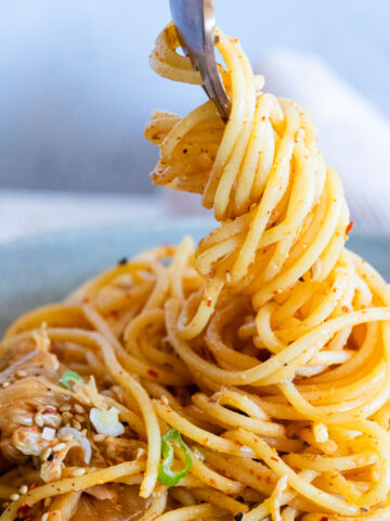 Creamy kimchi pasta twirled on a fork.