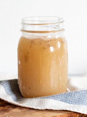 Bone broth in glass container.