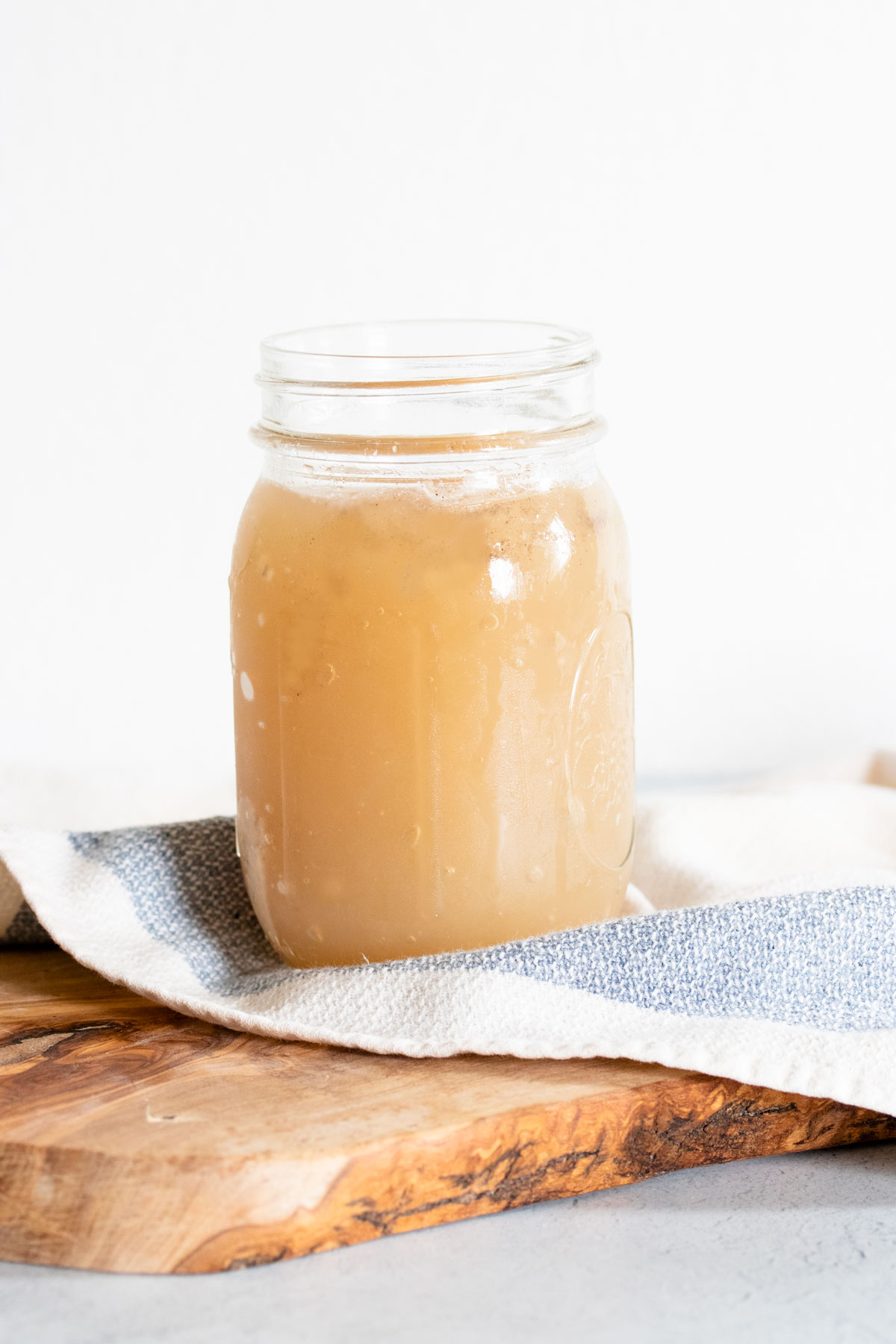 Pork bone broth in a glass container.