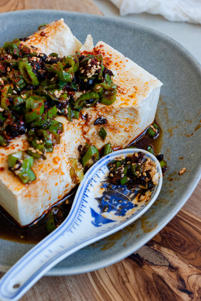 silken tofu with chili soy sauce topped with sesame seeds