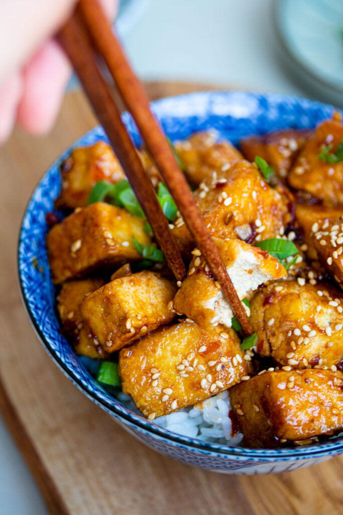 Honey sesame pan-fried tofu with chopsticks