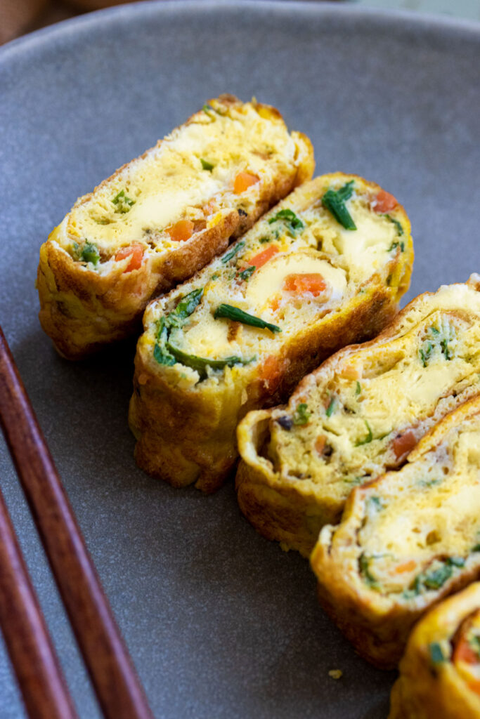 korean rolled omelette with chopsticks