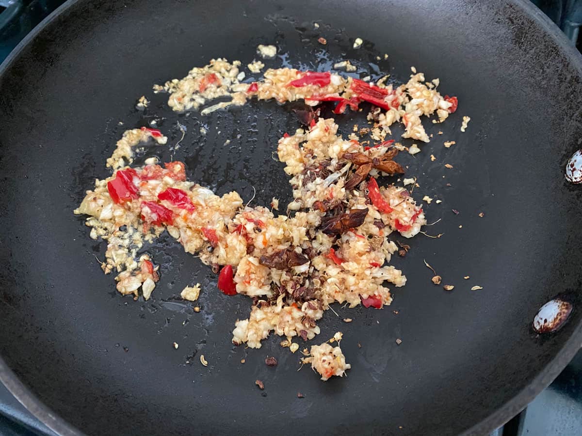 frying aromatic ingredients in pan