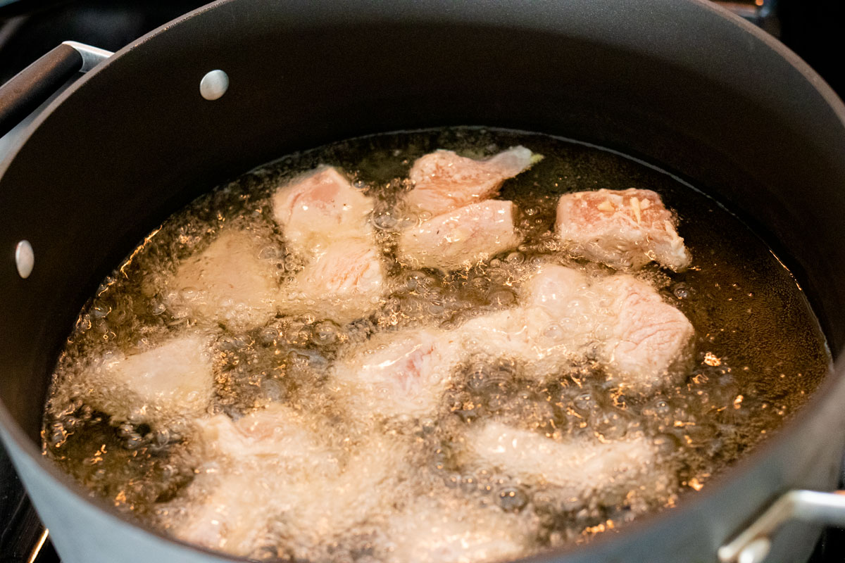 Chicken frying in oil.