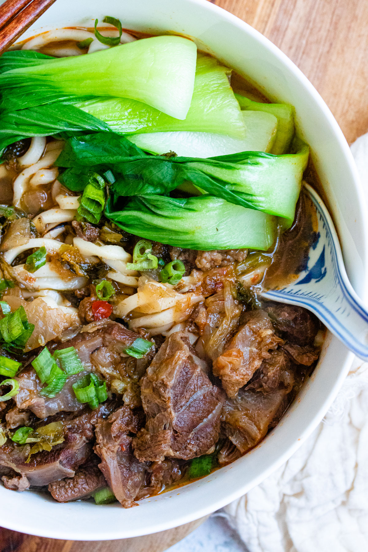 Taiwanese beef noodle soup in big white bowl. 