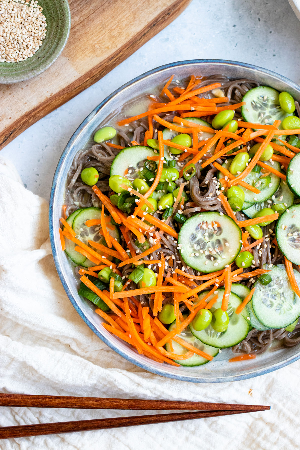 Miso sesame soba noodles topped with cucumber, carrots, and edamame.
