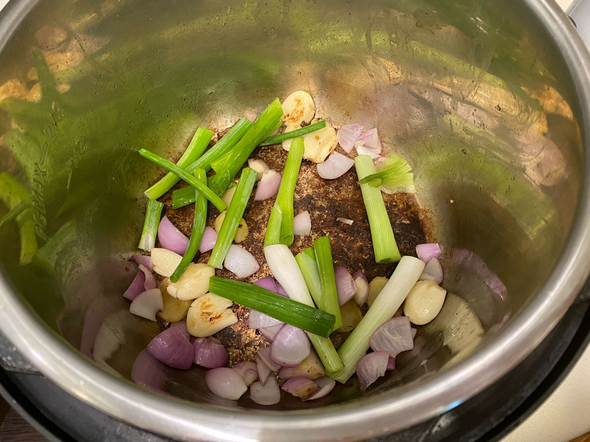 Add aromatics to Instant Pot.