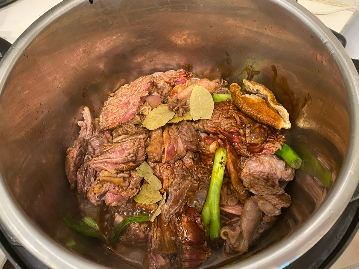 Add sauces to the pot over the beef.