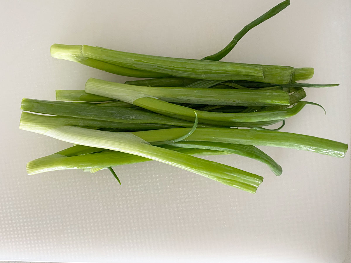 Slice scallions in half.