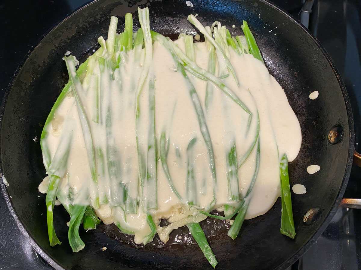 Add scallions to pan with batter.