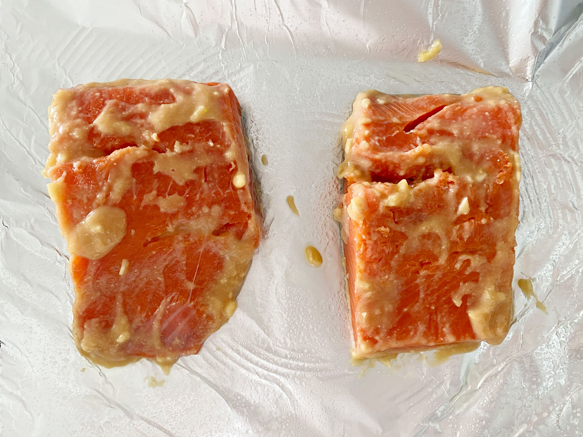 Marinated salmon on baking sheet.