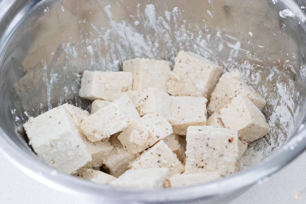 Firm tofu coated in cornstarch.