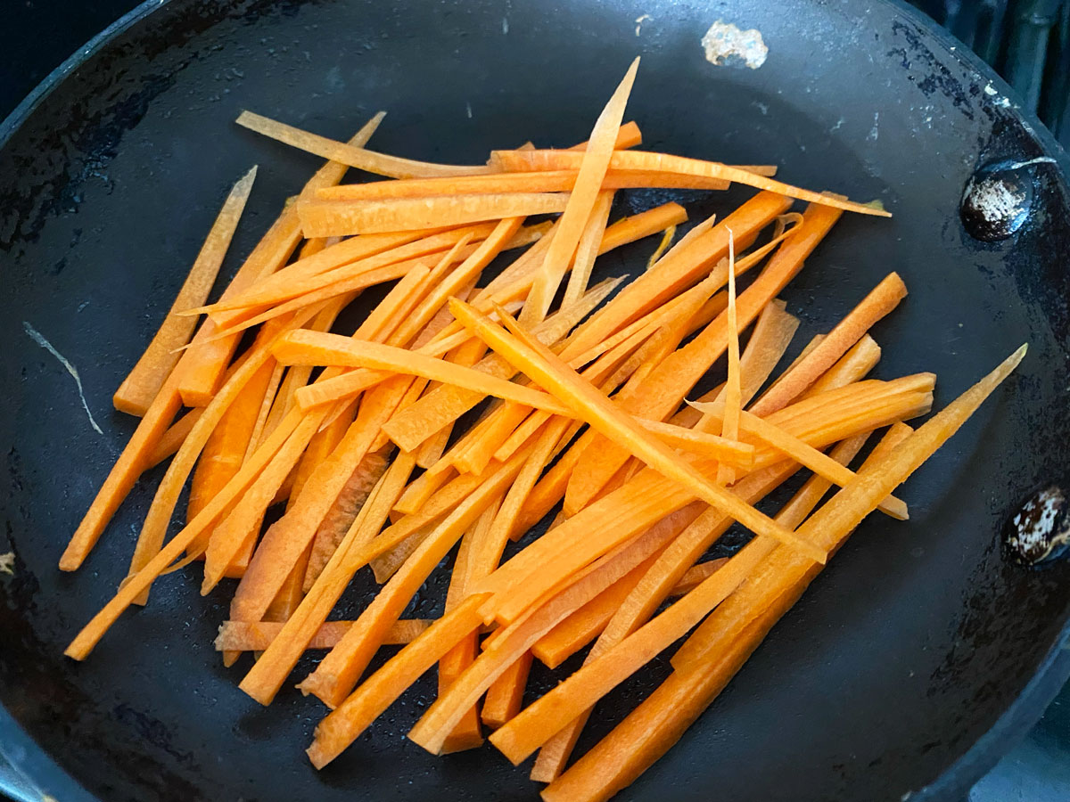 Julienned carrots on pan.