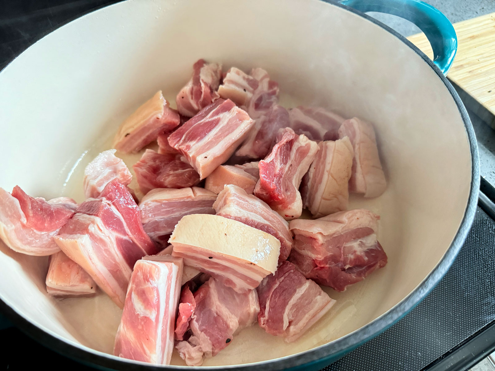 Place sliced pork belly in hot pan.